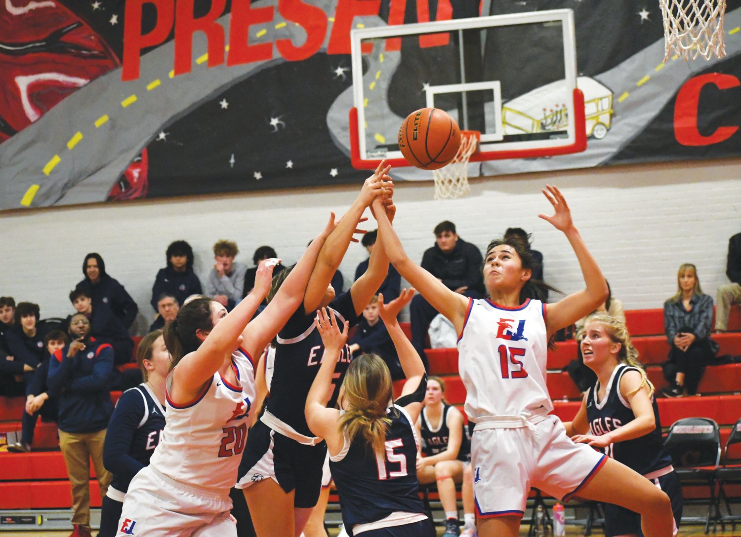 EJ’s Alyssa Vandenberg and Penina Vailolo reach for a rebound while surrounded by Eagles players.